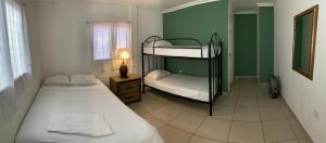 a bedroom with two bunk beds and a window at Palmira Hostel in Tegucigalpa