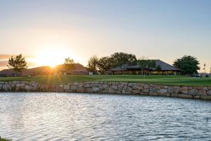 a golf course with a stone wall next to a lake at Villa #8 in St. George
