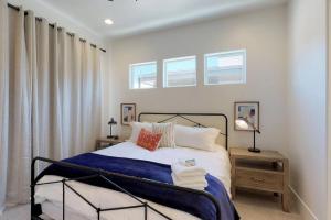 a bedroom with a bed with a blue blanket at Villa #8 in St. George