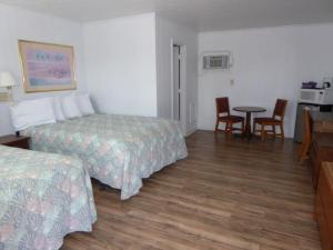 Ein Bett oder Betten in einem Zimmer der Unterkunft Swell Motel