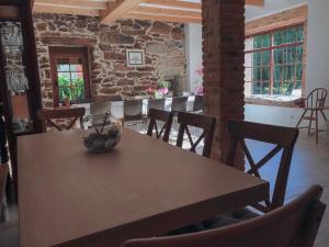 a dining room with a wooden table and chairs at Casa Idalia in Ourense