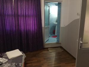 a room with a purple curtain and a mirror at Casa Stefania in Eforie Nord +18 photos
