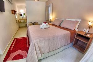 Cama ou camas em um quarto em Club do Balanço Pousada e Restaurante
