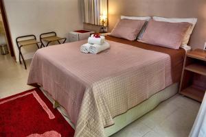 Cama ou camas em um quarto em Club do Balanço Pousada e Restaurante