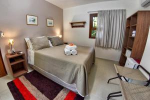 Cama ou camas em um quarto em Club do Balanço Pousada e Restaurante