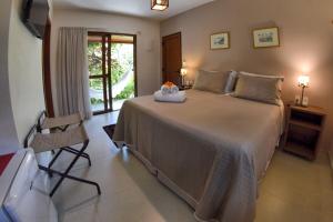 Cama ou camas em um quarto em Club do Balanço Pousada e Restaurante