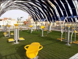 un parque infantil con sillas amarillas en la hierba en Chalets in Porto Sharm - Families Only AN en Sharm El Sheikh