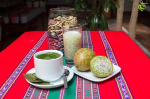 a table with a cup of coffee and a plate of food at Sonqo Killa del Colca in Chivay +32 photos