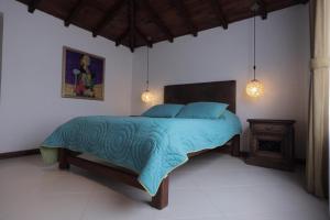 A bed or beds in a room at Hotel Boutique La Carreta