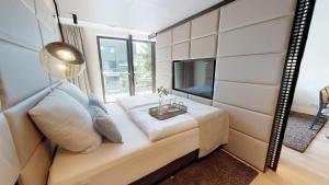- un salon avec un canapé et une télévision dans l'établissement White Pearl Apartment 2.04, à Timmendorfer Strand