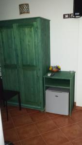un armario verde y un escritorio en una habitación en B&B San Domenico, en Realmonte