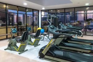 a gym with treadmills and elliptical machines at Boulevard Residencial in Salvador