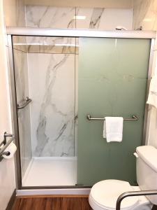 a shower with a glass door in a bathroom at Motel 6-Parkersburg, WV in Parkersburg