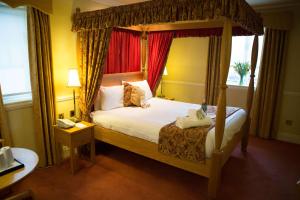 a bedroom with a canopy bed and a telephone at Best Western Gables Hotel in Falfield +52 photos