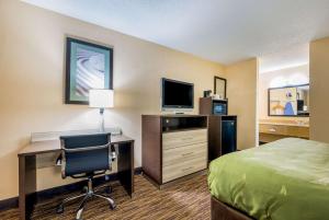 a hotel room with a bed and a desk with a computer at Quality Inn Cullman I-65 exit 310 in Cullman