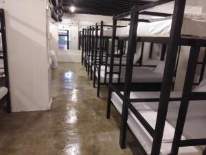 a row of bunk beds in a room at Dormitels.ph UST in Manila
