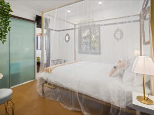 a bedroom with a large bed with a glass wall at Anville Court in Brisbane