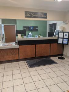 a reception desk with a sign that reads the truth in tune at AmericInn by Wyndham Davenport in Davenport