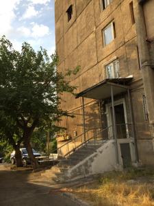 a building with a staircase in front of a building at Massiv Apt in Yerevan
