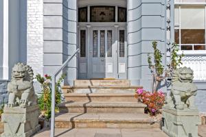 a front door of a house with two stone statues at Waratah On York in Launceston