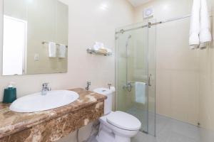 a bathroom with a sink and a toilet and a shower at Simone's Shophouse - Not a hotel in Ho Chi Minh City
