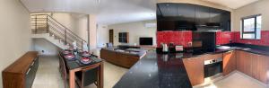 a kitchen and living room with a counter top and a staircase at 66 Dorp Street Apartment in Polokwane +7 photos