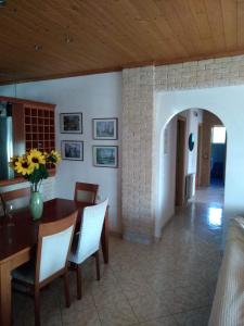 a kitchen and dining room with a table and chairs at Villa Thanos in Marathias