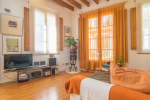 a living room with a couch and a television at Miraclet - ADULTS ONLY in Palma de Mallorca