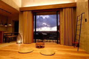 a living room with a large glass door with a view at Kaiza in Nanjo