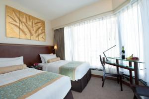 Llit o llits en una habitació de Brighton Hotel Hong Kong