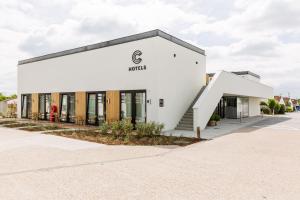 a white building with a sign on it at C-Hotels Zeegalm in Middelkerke