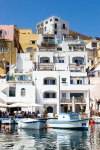 a large white building with boats in the water at San Michele in Procida