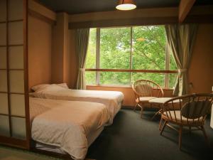 Кровать или кровати в номере Hotel&Resort Yamanouchi Hills