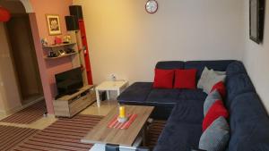 a living room with a blue couch and a table at Liza Apartment in Ulcinj
