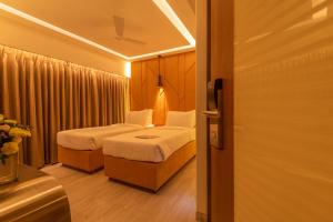 Postel nebo postele na pokoji v ubytování Hotel Metropole Inn
