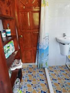 a bathroom with a sink and a toilet and a shower at Leyte Seaview Stay in Himay-añgan