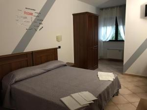 a bedroom with a bed with two towels on it at Hotel Paradiso in Collina in San Giovanni Rotondo