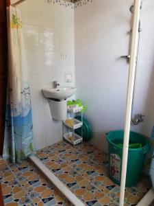 a bathroom with a sink and a toilet and a shower at Leyte Seaview Stay in Himay-añgan