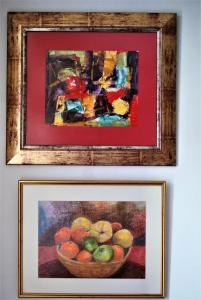 two paintings of a bowl of fruit on a wall at the bougainvillea house in Symi