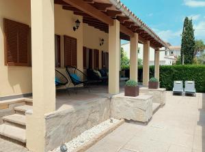 a patio of a house with chairs and tables at Casa Coromines in Alcudia