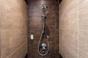 
a bathroom with a toilet and a shower stall at Rius Hotel Lviv in Lviv
