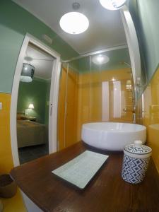 a bathroom with a large tub and a sink at Le Stanze del Borgo in Nettuno