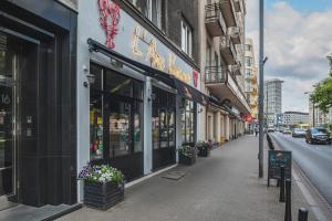 a street with a store on the side of a building at Sandomierska P&O Apartments in Warsaw