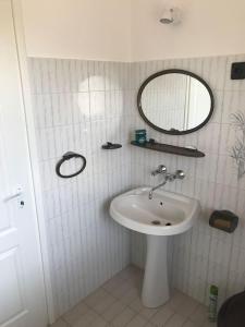 a bathroom with a sink and a mirror at Malom Vendégház in Szarvas