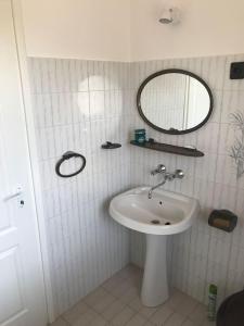 a bathroom with a sink and a mirror at Malom Vendégház in Szarvas +5 photos