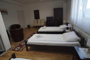 A bed or beds in a room at Guest house Royal II