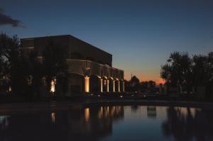 a building with a pool of water in front of it at Villa de Lua in Leporano