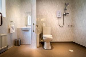 a bathroom with a shower and a toilet and a sink at Best Western The Shrubbery in Ilminster