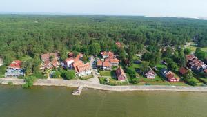 an aerial view of a large house on an island in the water at Vila Baldininkas in Neringa