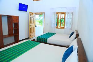 Voodi või voodid majutusasutuse Shan Guest and Restaurant Nilaveli toas